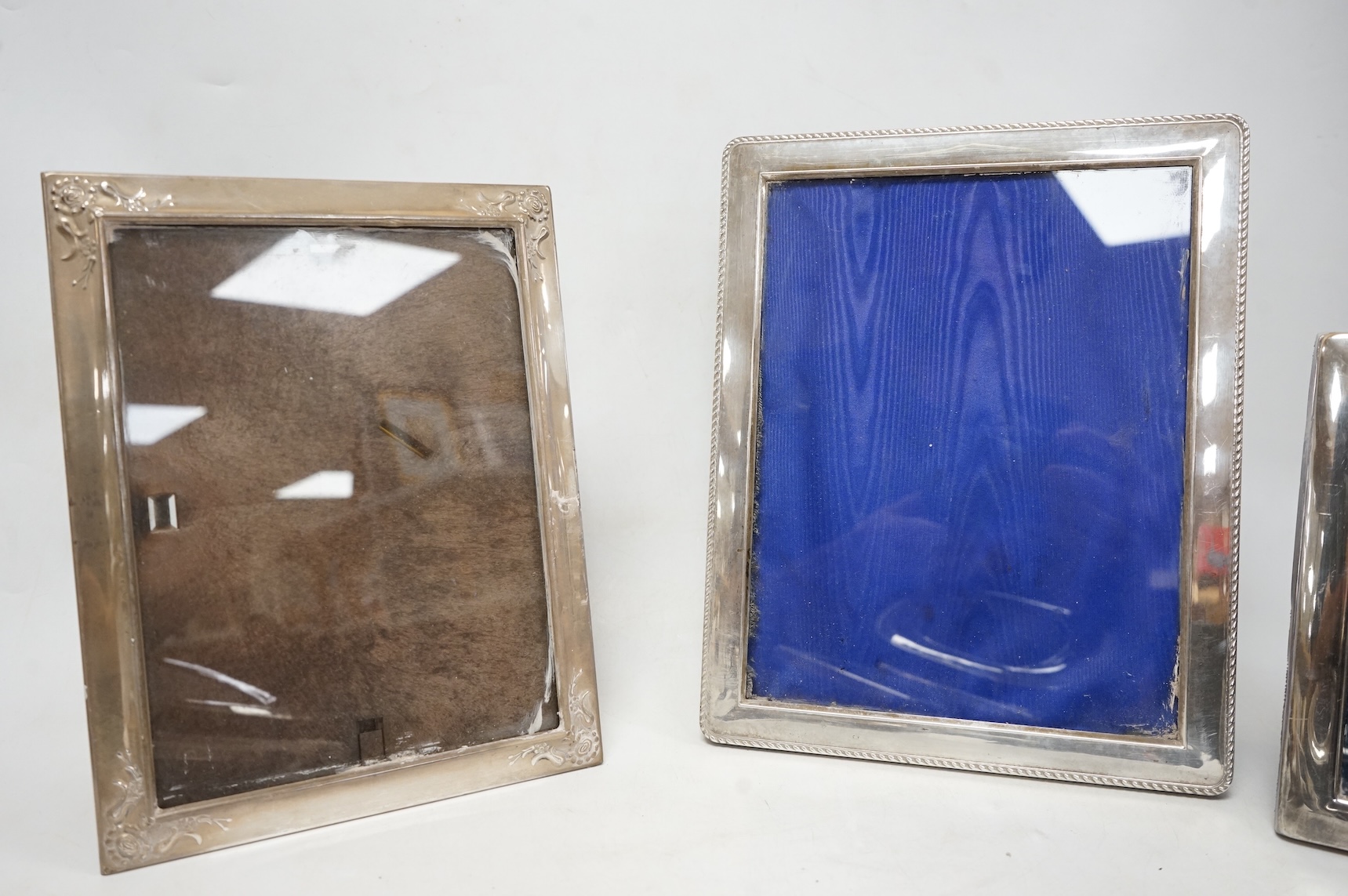 A pair of modern engine turned silver mounted rectangular photograph frames, by Carr's of Sheffield, Sheffield, 1992/3, 14.8cm, together with seven other modern silver mounted photograph frames, largest 23.1cm.
